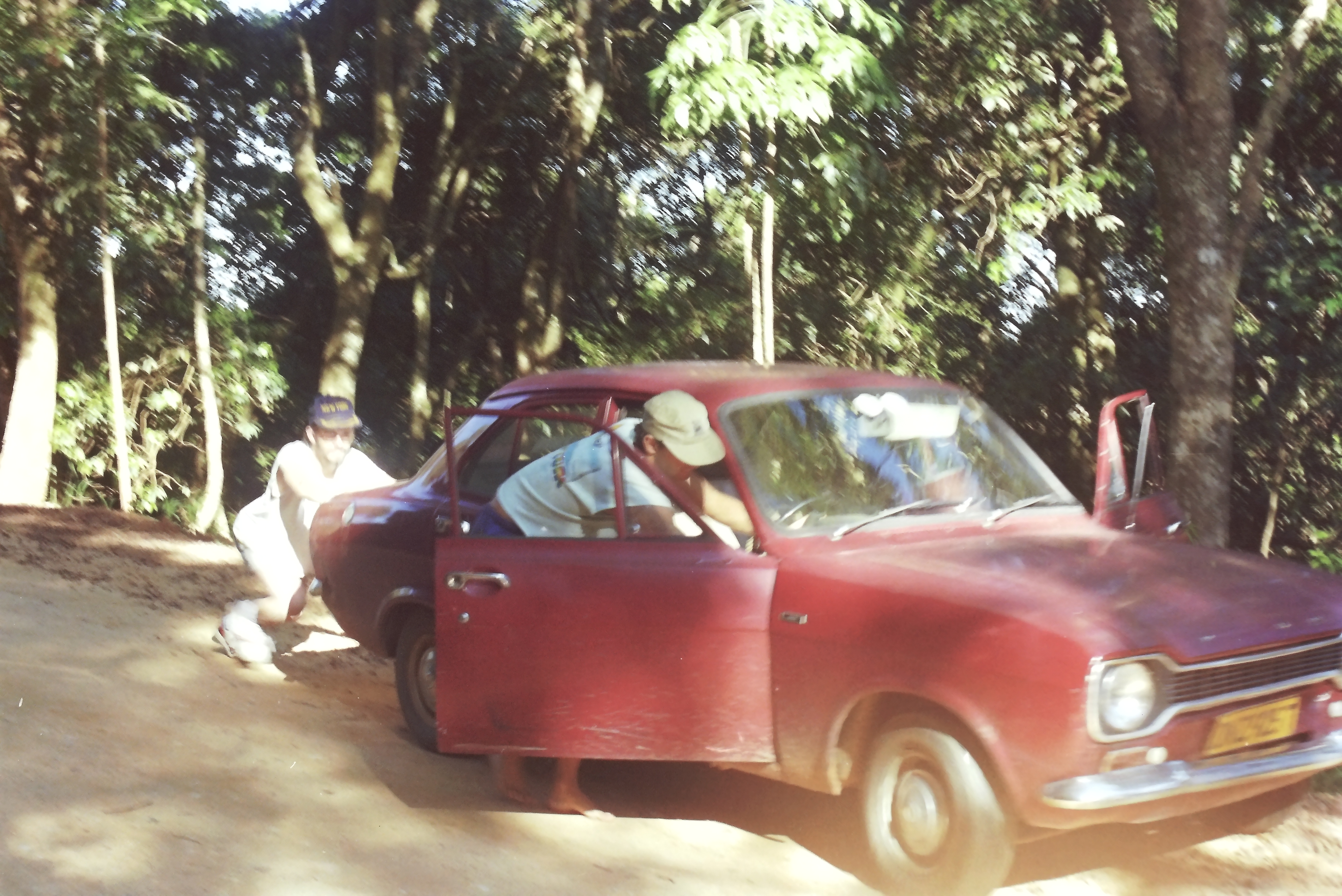 Andre and John pushing Andre's car