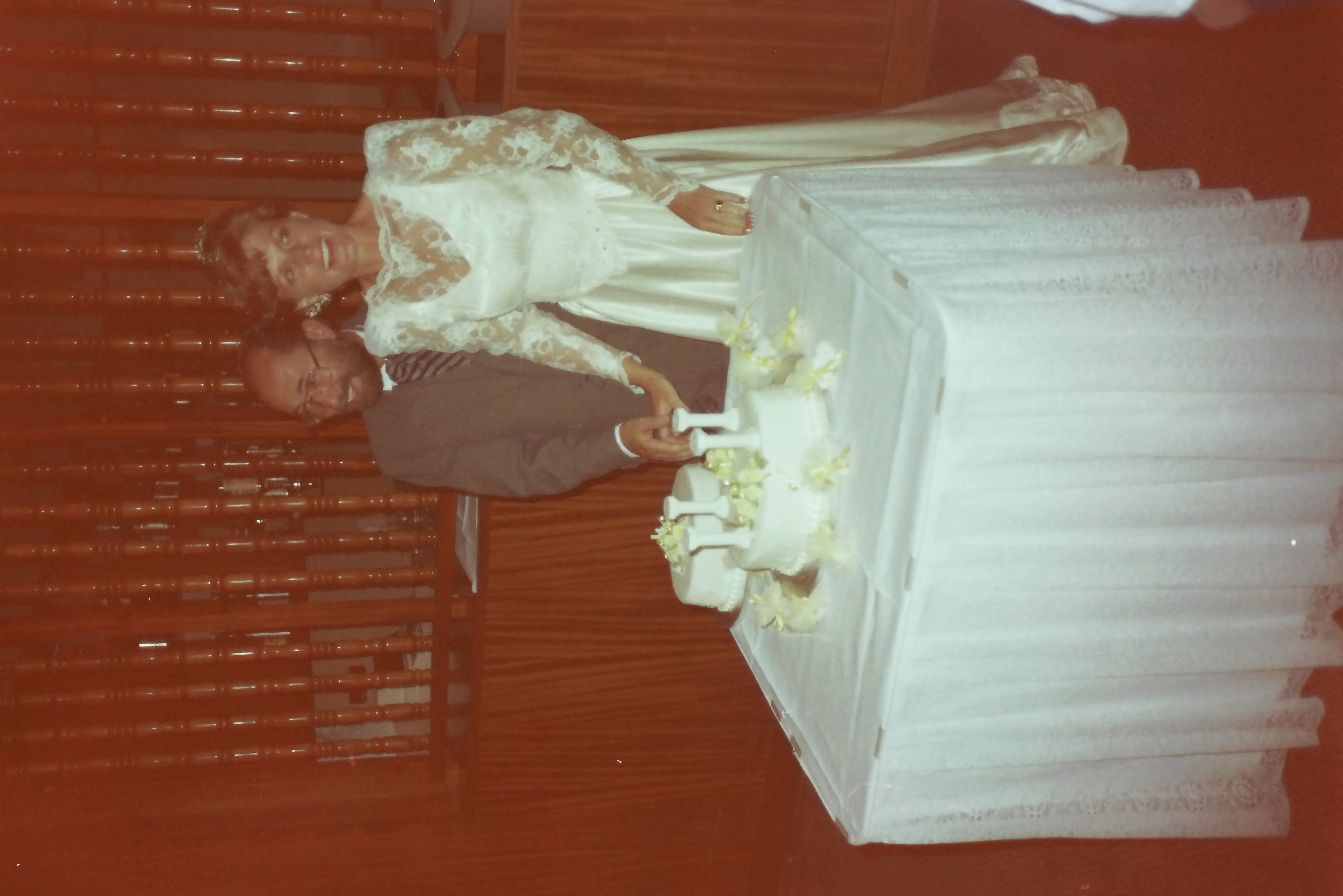 Derek(?) and Maggie(?) cutting their wedding cake